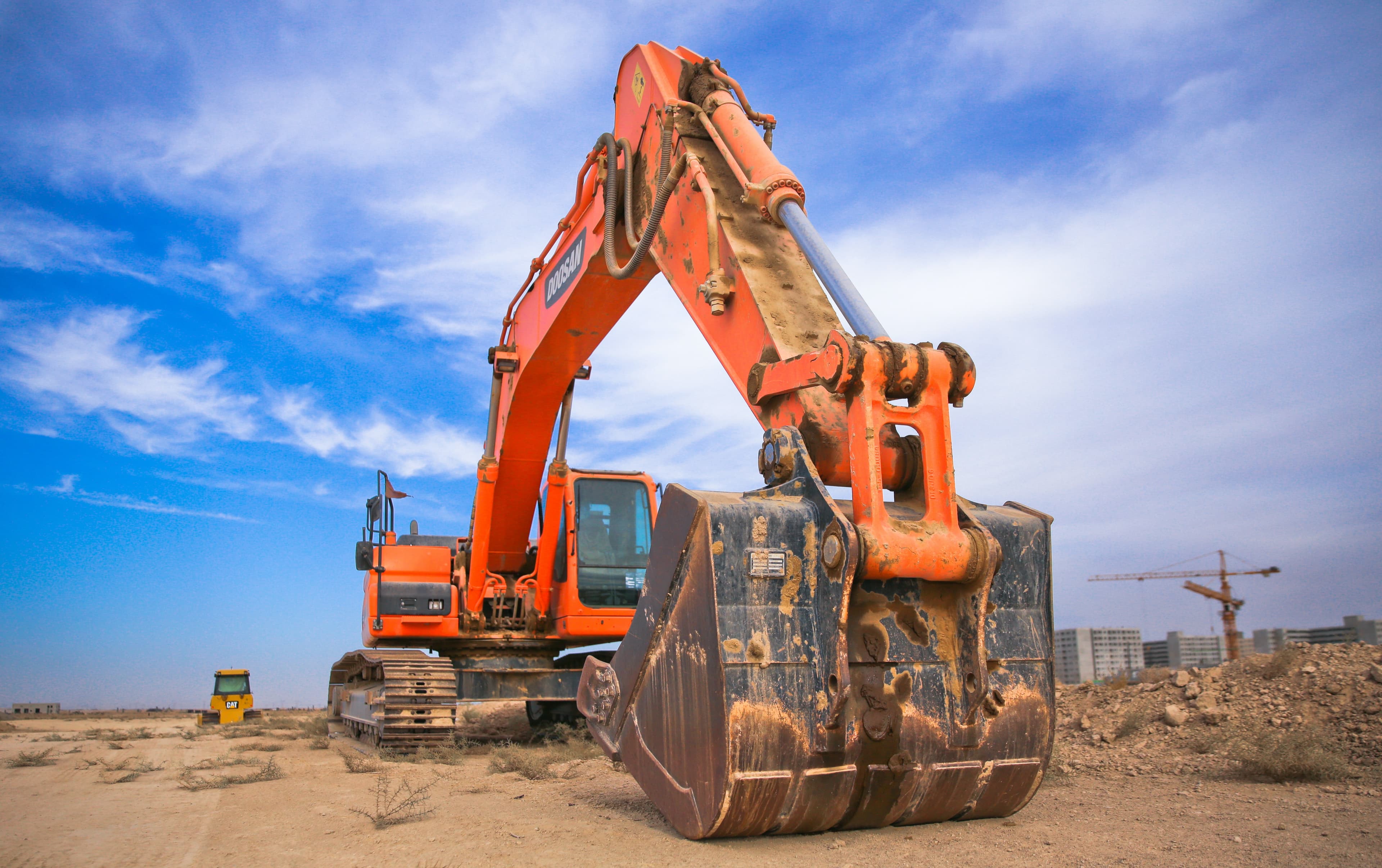 orange tractor on a construction lot