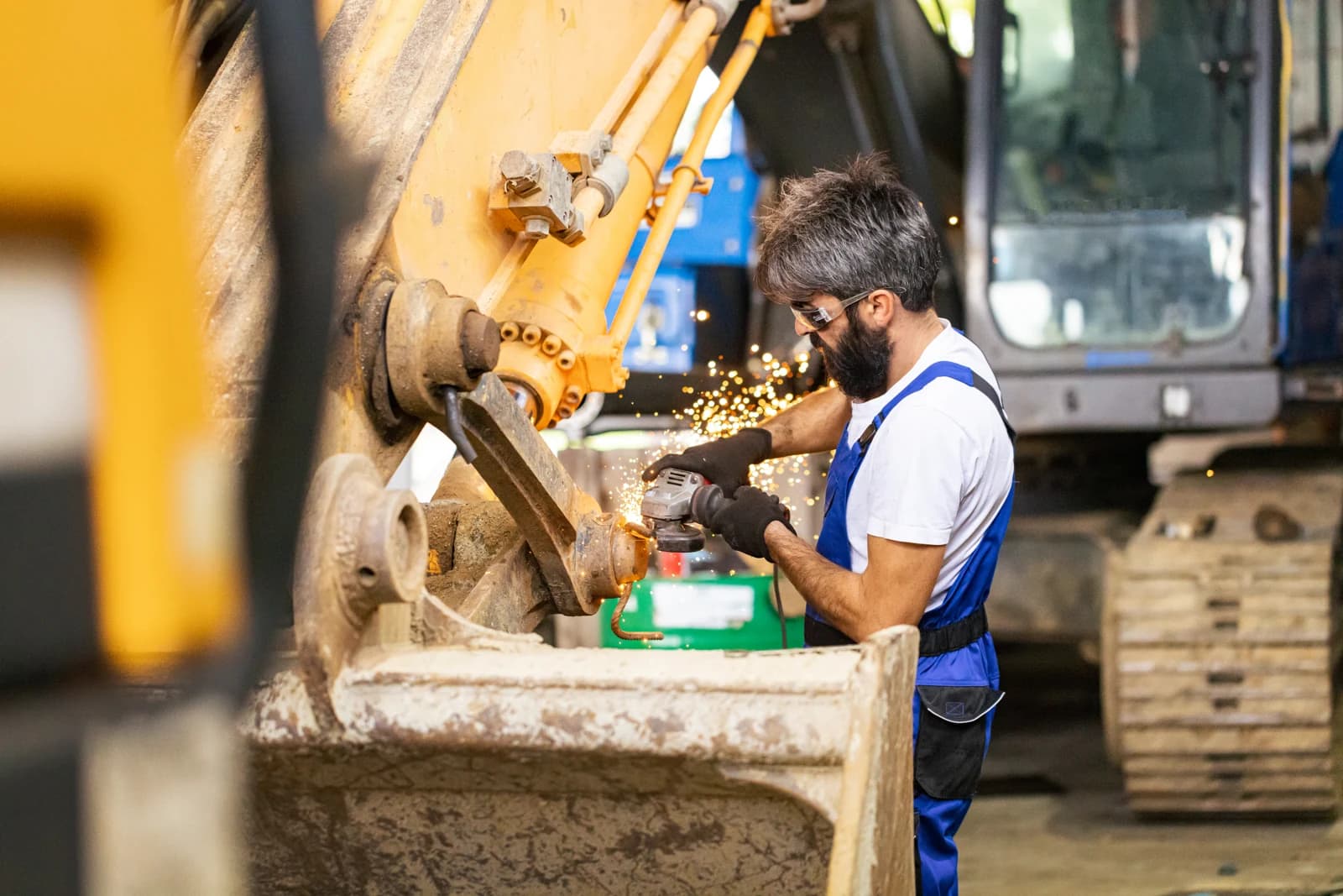 Technician servicing a piece of rental equipment in the shop